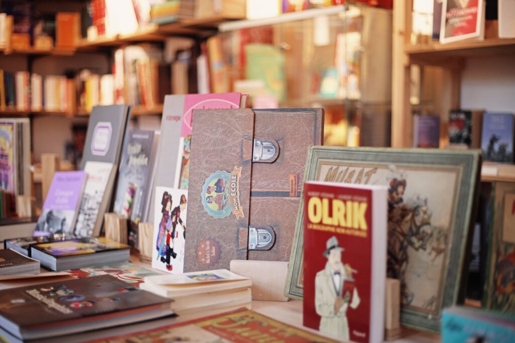 Böcker står uppradade på ett bord i en bokhandel.