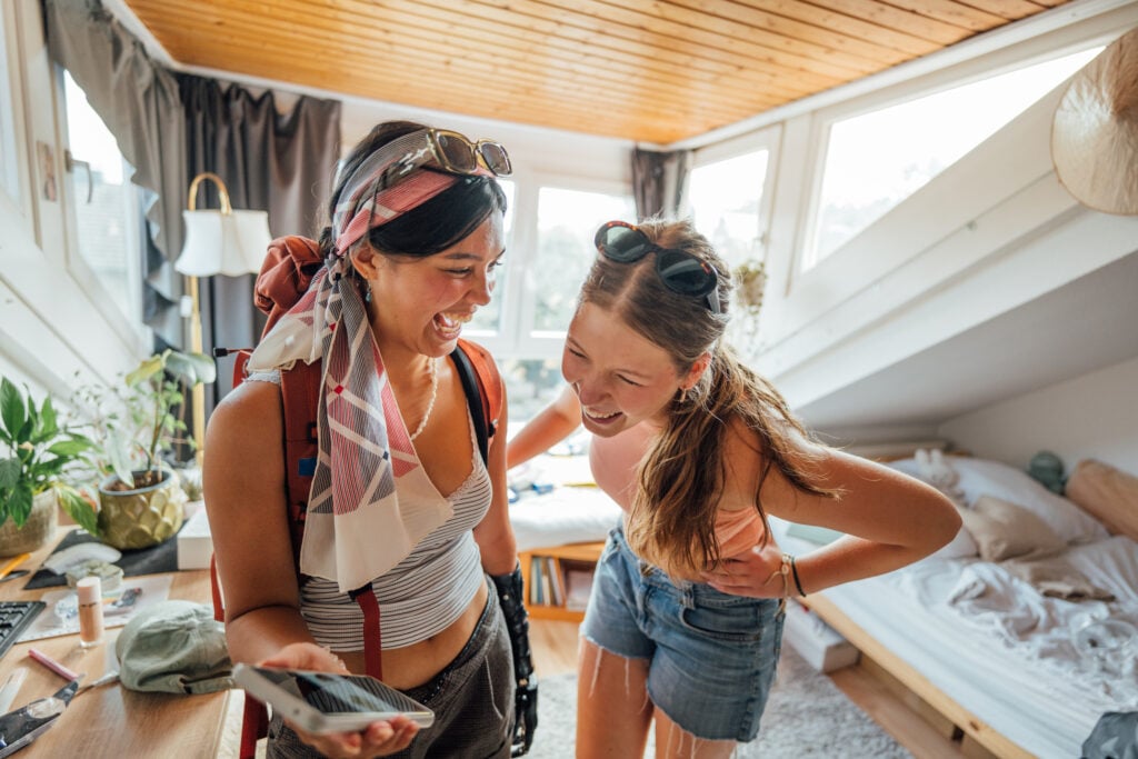 Two young women getting ready/packing and leaving for a backpacking Interrail trip and riding trains through Europe. Part of a series with video