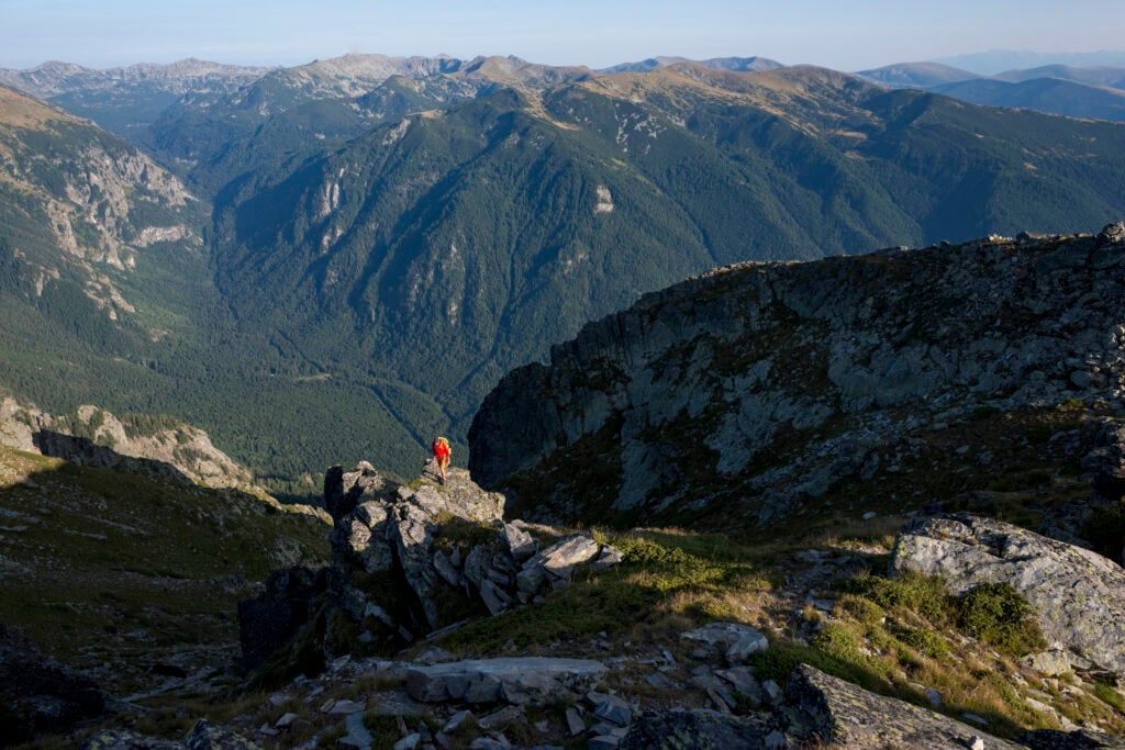 A hiker on a high ridge near Maliovitsa in the Rila mountains
