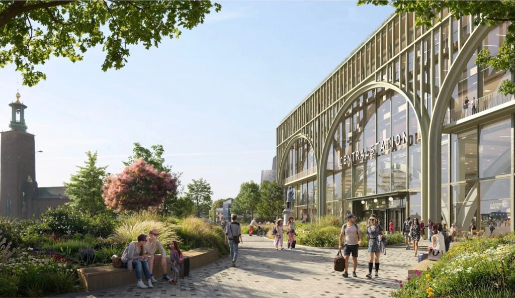 Grönskande torg söder om Stockholm C med Stockholm stadshus i fonden. Visionsbild om framtida miljö.