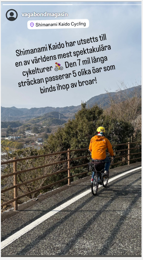 En person i orange jacka cyklar längs med en väg på hög höjd. 