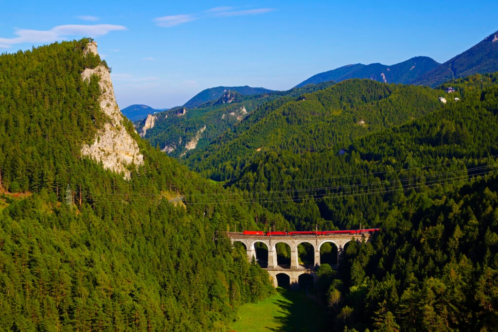 Panorama of the Polleroswand, Kalte Rinne Viaduct with Passenger train and the region Semmering; UNESCO World Heritage Site; built 1848-1854;