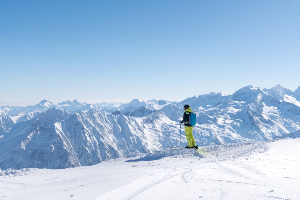 Professional freeride skier Sandra Lahnsteiner enjoying the beautiful mountain landscape in the Sportgastein ski area in Austria.